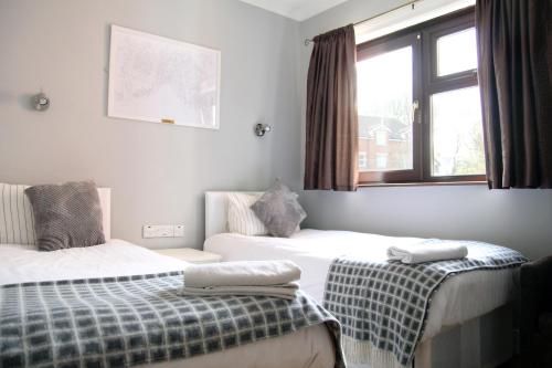 a bedroom with two beds and a window at Greenmount Bed and Breakfast in Belfast