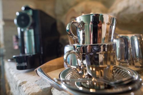 a silver coffee cup sitting on top of a counter at St.Michaels Bistro in Painswick