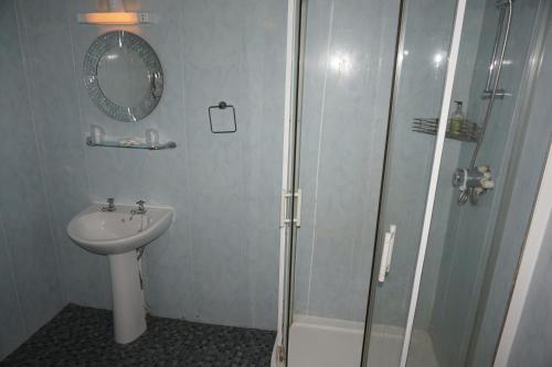 a bathroom with a shower and a sink at The Butlers Hotel in Leeds