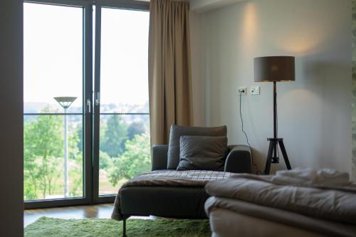 a living room with a couch and a window at Boutiquehotel Genusswerk Eifel in Körperich