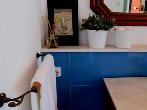 a towel hanging on a towel rack in a bathroom at Pátio das Andorinhas in Ferreira do Alentejo