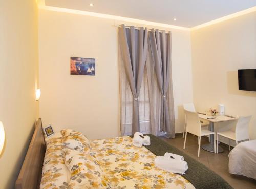 a hotel room with a bed and a table and a room at YourHome - Casa Aristide in Sant'Agnello