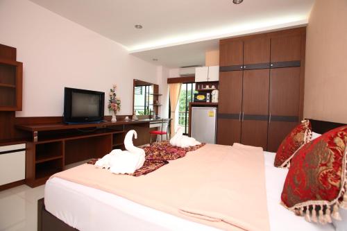 Un dormitorio con una cama con dos cisnes. en Pattara Place, en Chiang Mai