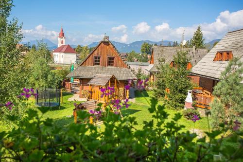 an aerial view of a house with flowers in the yard at Rekreačné chalupy in Liptovský Trnovec