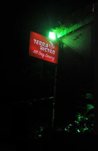a red sign on a building with a green light at Platinum Residence in Dhaka