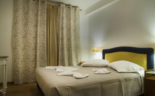 a bedroom with a bed with two towels on it at Maisonette House Minos in Heraklio