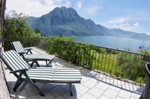 a balcony with chairs and a view of a lake at Casa Emilia in Riva di Solto