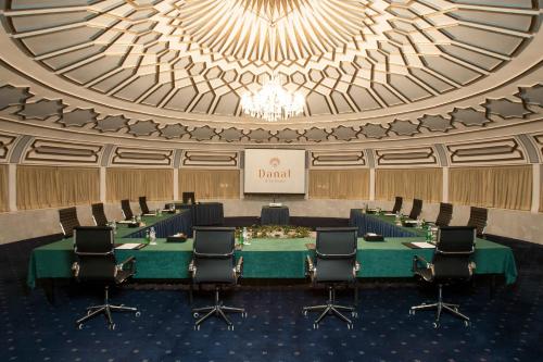 a meeting room with a long table and chairs at Danat Al Ain Resort in Al Ain