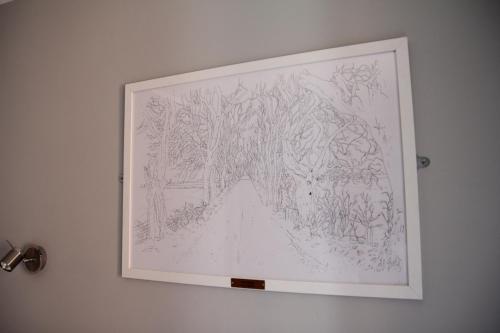 a framed drawing of a forest on a wall at Greenmount Bed and Breakfast in Belfast