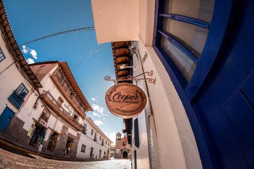 un panneau indiquant une taverne suspendue sur le côté d'un bâtiment dans l'établissement Cooper Hotel Boutique, à Cusco
