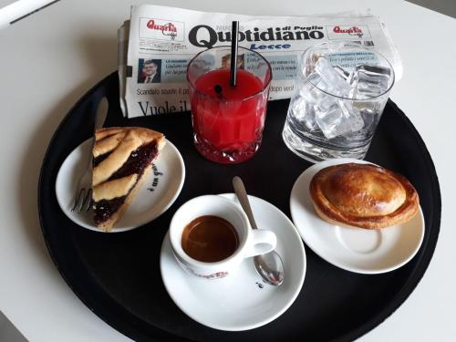 a plate of food with a cup of coffee and pancakes at Hotel Morini in San Foca