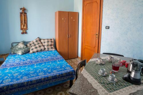 a bedroom with a bed and two tables with drinks on it at Patty green house in Castellana Grotte