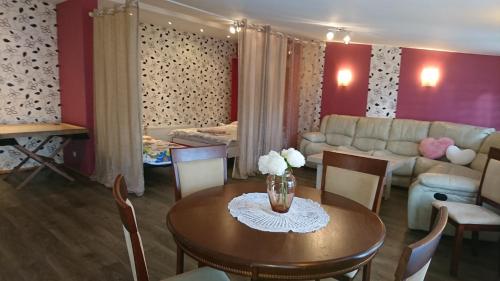 a living room with a table and a couch at Holiday Home Noras Nams in Cēsis