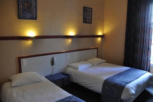 Katil atau katil-katil dalam bilik di Citotel Hôtel Cesar