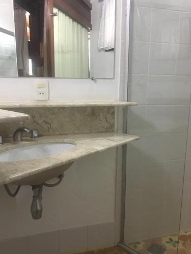 a bathroom with a sink and a mirror at Calcada Sao Jose in Tiradentes
