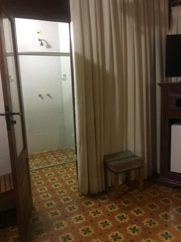 a room with a door and a window and a floor at Calcada Sao Jose in Tiradentes