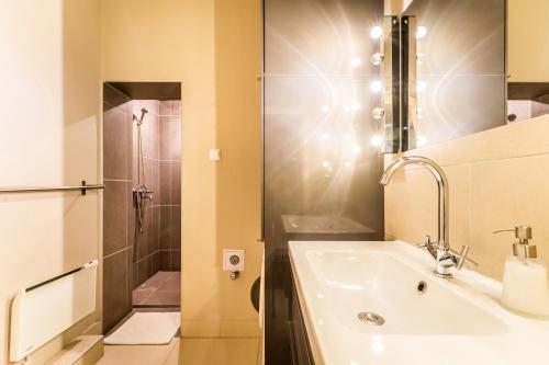 a bathroom with a sink and a shower at TREASURE BOX - Entire Apartment in the center in Budapest