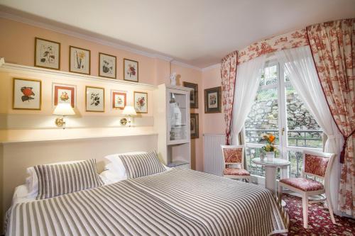 a bedroom with a bed and a window at Karlsbad Grande Madonna in Karlovy Vary