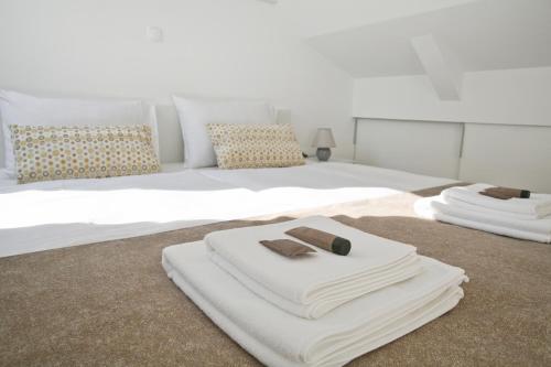 a bedroom with two white towels on a bed at Apartments Hiša Pod Gradom in Ljubljana