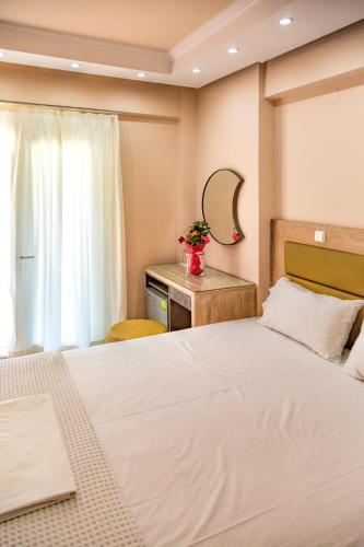 Ένα ή περισσότερα κρεβάτια σε δωμάτιο στο Le Monde SeaView Suites