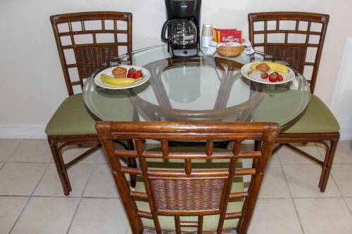 a glass table with two plates of food on it at Steinhatchee River Inn and Marina in Steinhatchee
