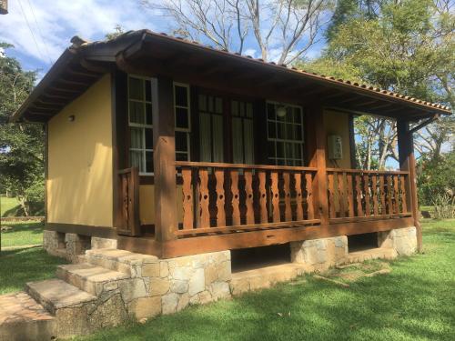 a small house with a porch and a deck at Calcada Sao Jose in Tiradentes