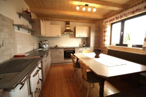 a kitchen with a wooden floor and a counter top at Almhaus Pleschinhof in Hochrindl
