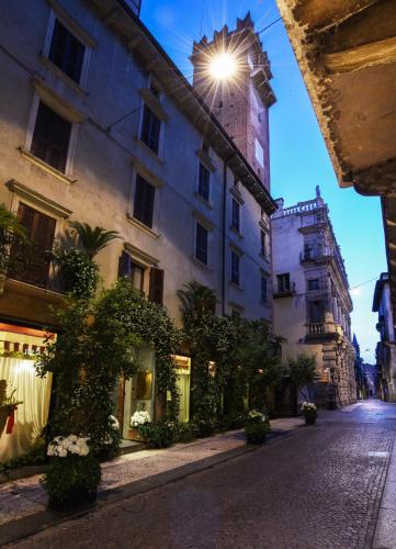 a building with a light on the top of it at Hotel Gabbia D'Oro in Verona