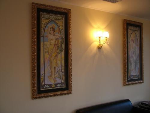 a painting of a woman on a wall with a light at Hotel San Giorgio in Crotone