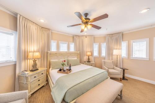 a bedroom with a bed and a ceiling fan at Henderson Park Inn in Destin