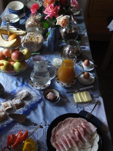 a table with breakfast foods and fruits on it at Maglanderhof in Unterlamm