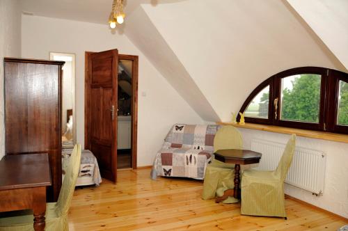 a bedroom with a bed and a table and chairs at Dom nad Rozlewiskiem in Zamość