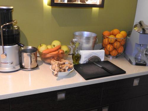 a counter with bowls of fruits and vegetables on it at Hotel Sonnenhof in Marlengo