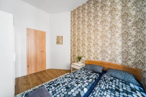 a bedroom with a bed with blue pillows at Nyár 3 Bedroom Centre Entire Home in Budapest