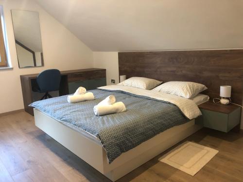 a bedroom with a bed with two towels on it at Apartmani Izvor - Tuheljske Toplice in Tuheljske Toplice