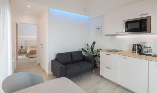 a kitchen with a black chair in a room at Apartments Panorama in Trogir