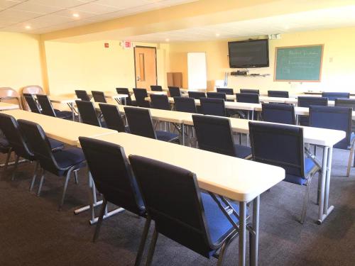 a classroom with tables and chairs and a chalkboard at Days Inn by Wyndham Grove City Columbus South in Grove City
