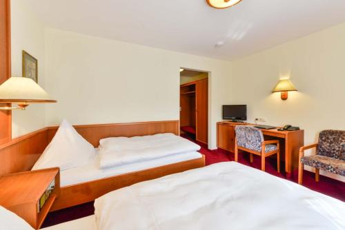 Una cama o camas en una habitación de Hotel Sixt
