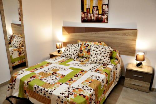 コニル・デ・ラ・フロンテーラにあるApartamento Manoliのベッドルーム(カラフルなキルトのベッド付)