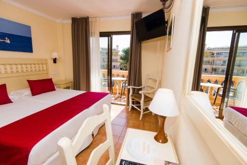 a hotel room with a bed and a balcony at Bell Port Hotel in Cala Ratjada