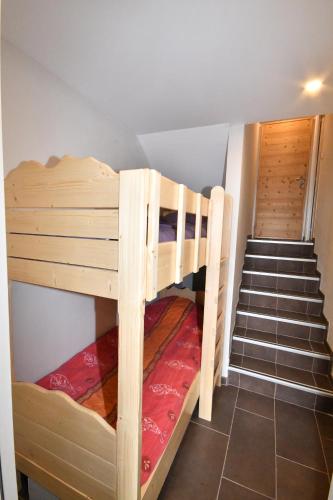 a room with two bunk beds and a staircase at Le Lauranoure - 205 in L'Alpe-d'Huez