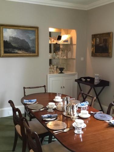 a dining room with a wooden table and chairs at Bedrule Old Manse B&B in Hawick