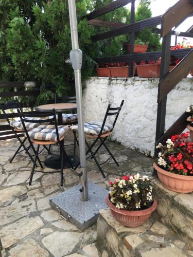 a patio with a table and chairs and flowers at Apartment Queen in Belgrade
