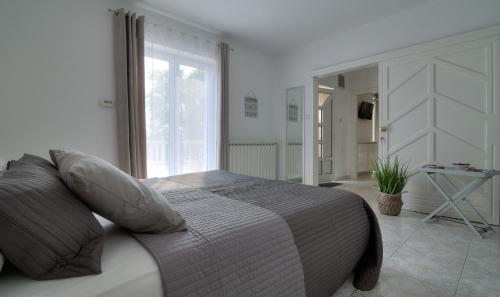 a bedroom with a bed and a large window at Apartment Barbara in Senj