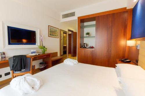 Postel nebo postele na pokoji v ubytování Hotel Nettuno