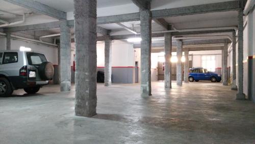 a parking garage with two cars parked in it at La Albarizuela in Jerez de la Frontera