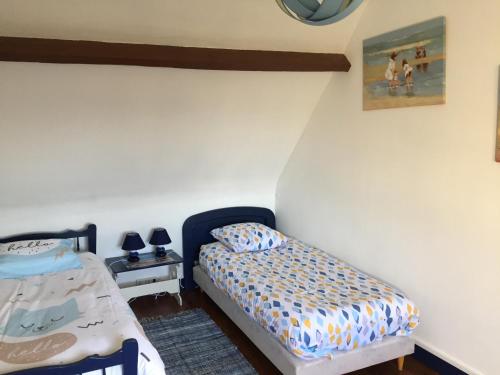 um quarto com uma cama ao lado de uma parede em au calme à Etretat em Étretat