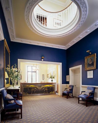 a large room with a round ceiling with a fireplace at Ballymascanlon Hotel and Golf Resort in Dundalk