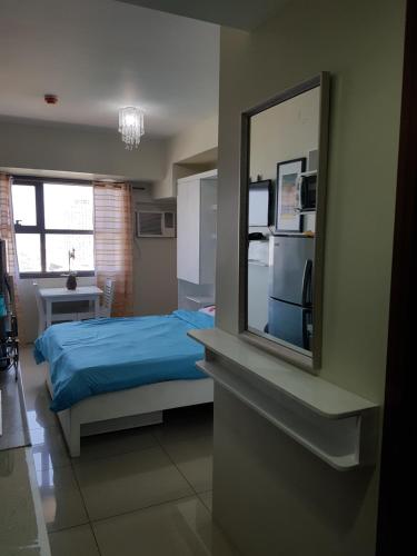 Postel nebo postele na pokoji v ubytování KC Studio 1 at Horizons 101 Cebu