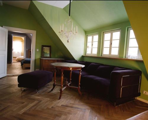 a living room with a couch and a table at Gutshaus Altbauhof in Dargun